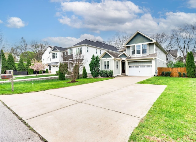 15 Westlawn Ct, Nashville, TN 37209 - view of front of house with concrete driveway, a front yard, fence, and a garage