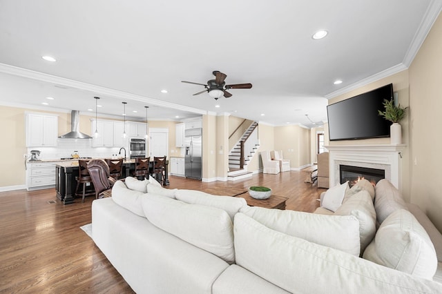15 Westlawn Ct, Nashville, TN 37209 - living area featuring baseboards, ornamental molding, a ceiling fan, wood finished floors, and stairs
