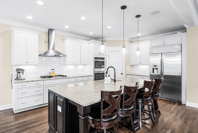 15 Westlawn Ct, Nashville, TN 37209 - kitchen featuring stainless steel appliances, white cabinetry, a sink, and wall chimney range hood