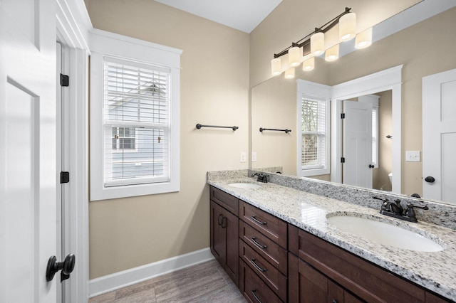 15 Westlawn Ct, Nashville, TN 37209 - bathroom with a sink, baseboards, double vanity, and wood finished floors