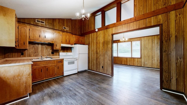 kitchen with a chandelier, under cabinet range hood, white appliances, and visible vents