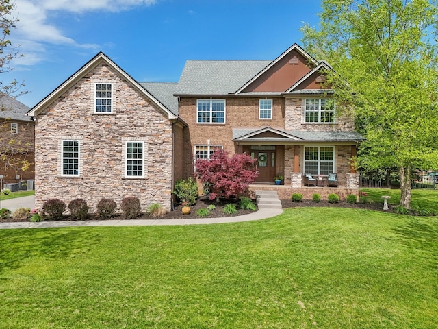 1702 Stoney Hill Ln, Spring Hill, TN 37174 - craftsman-style house featuring stone siding, roof with shingles, a porch, and a front lawn