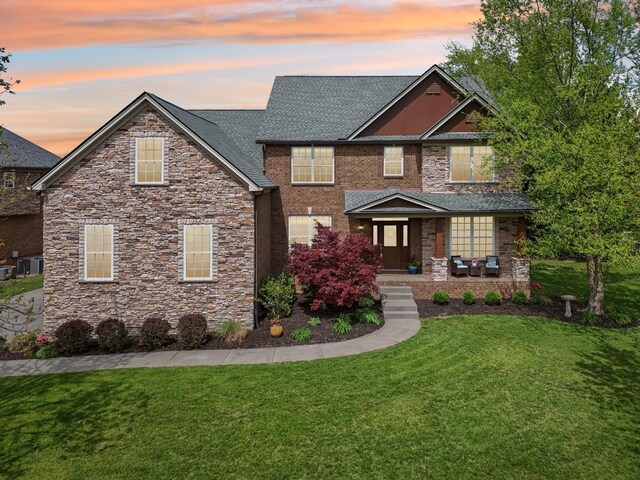 1702 Stoney Hill Ln, Spring Hill, TN 37174 - view of front facade featuring a yard, stone siding, covered porch, and a shingled roof