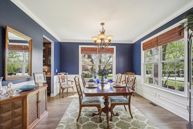 1702 Stoney Hill Ln, Spring Hill, TN 37174 - dining room with a wainscoted wall, wood finished floors, a chandelier, and visible vents