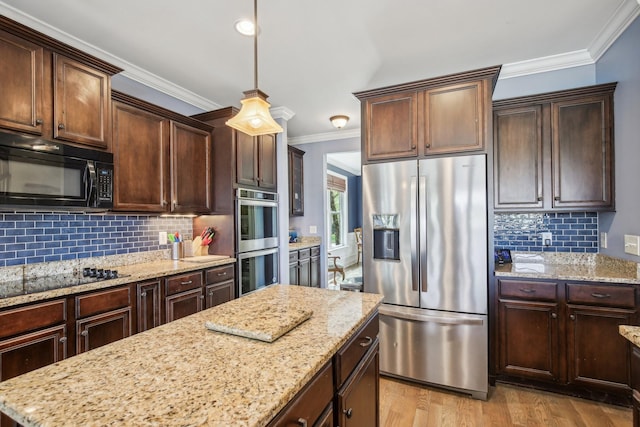 1702 Stoney Hill Ln, Spring Hill, TN 37174 - kitchen with ornamental molding, pendant lighting, light wood-style flooring, black appliances, and tasteful backsplash