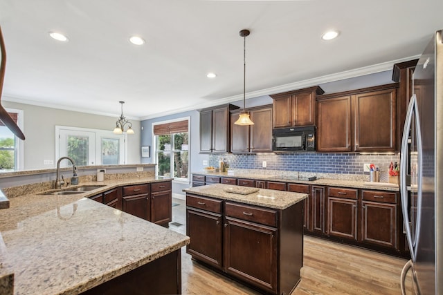 1702 Stoney Hill Ln, Spring Hill, TN 37174 - kitchen with a sink, a large island, recessed lighting, crown molding, and black appliances