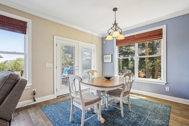 1702 Stoney Hill Ln, Spring Hill, TN 37174 - dining area featuring baseboards, crown molding, wood finished floors, and an inviting chandelier