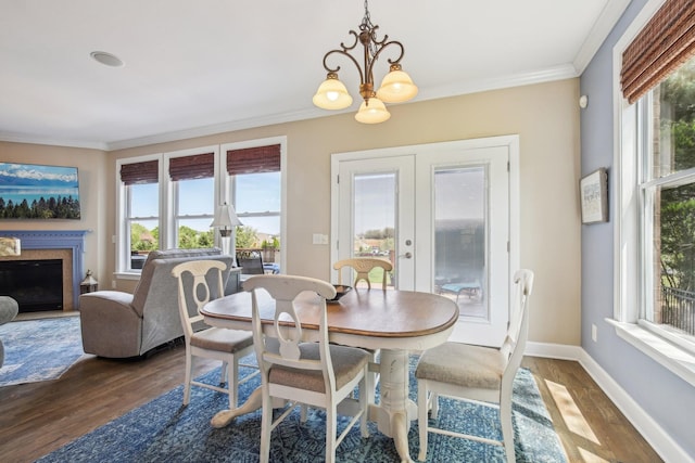 1702 Stoney Hill Ln, Spring Hill, TN 37174 - dining area featuring a notable chandelier, baseboards, crown molding, and wood finished floors