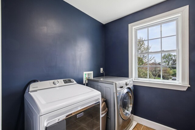 1702 Stoney Hill Ln, Spring Hill, TN 37174 - laundry room with washing machine and clothes dryer, tile patterned floors, baseboards, and laundry area