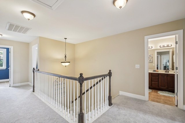 1702 Stoney Hill Ln, Spring Hill, TN 37174 - corridor with baseboards, visible vents, an upstairs landing, and light colored carpet