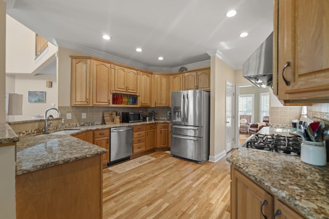 kitchen featuring stone countertops, a sink, backsplash, and appliances with stainless steel finishes
