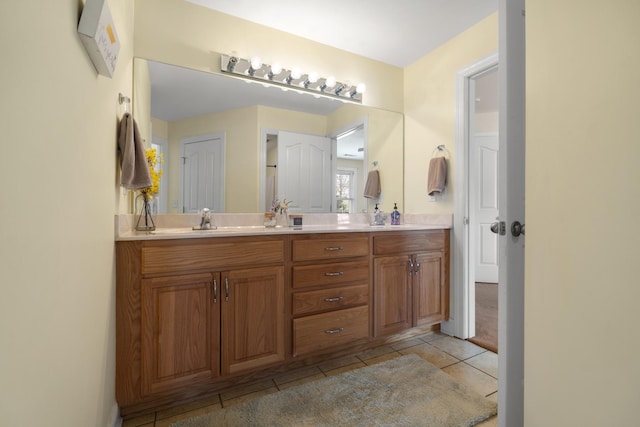 full bathroom featuring tile patterned floors, a sink, and double vanity