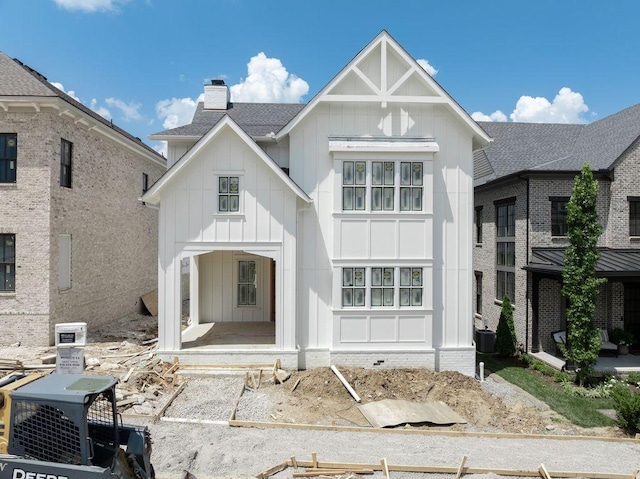 8024 Southvale Blvd, Franklin, TN 37064 - view of front of home featuring board and batten siding, a chimney, and roof with shingles