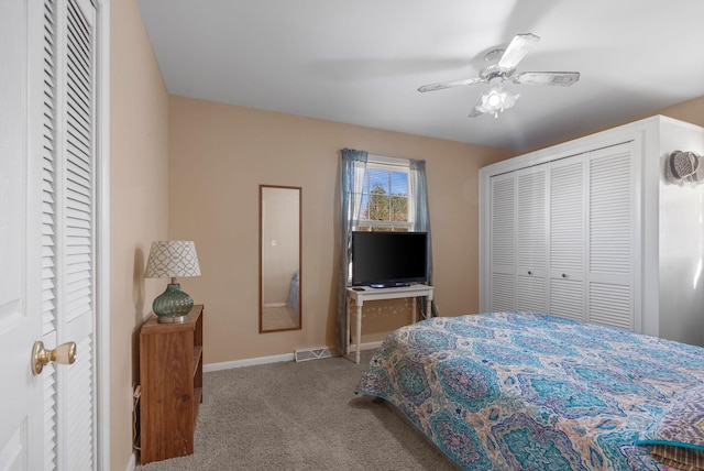 carpeted bedroom featuring visible vents, baseboards, and ceiling fan