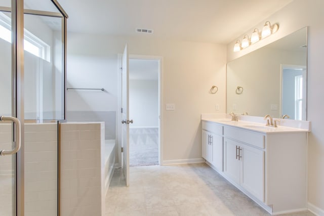 bathroom featuring tile patterned floors, double vanity, a sink, and visible vents