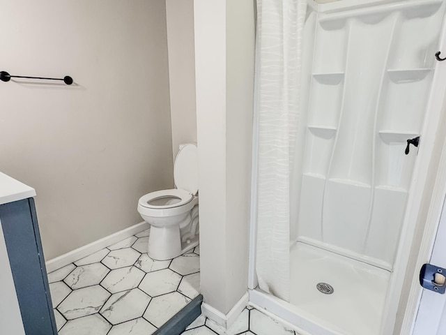 503 E Market St, Lebanon, TN 37087 - bathroom featuring toilet, baseboards, and a stall shower