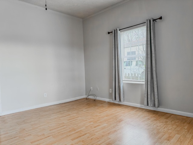 503 E Market St, Lebanon, TN 37087 - empty room featuring crown molding, light wood-style flooring, and baseboards