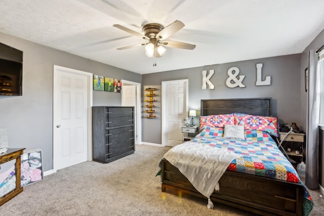 carpeted bedroom featuring baseboards and ceiling fan