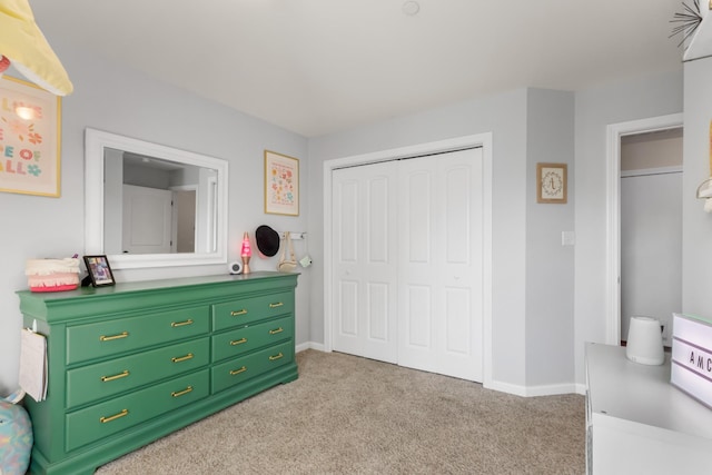 bedroom featuring a closet, baseboards, and light colored carpet