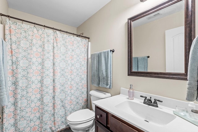 bathroom featuring vanity, visible vents, curtained shower, and toilet
