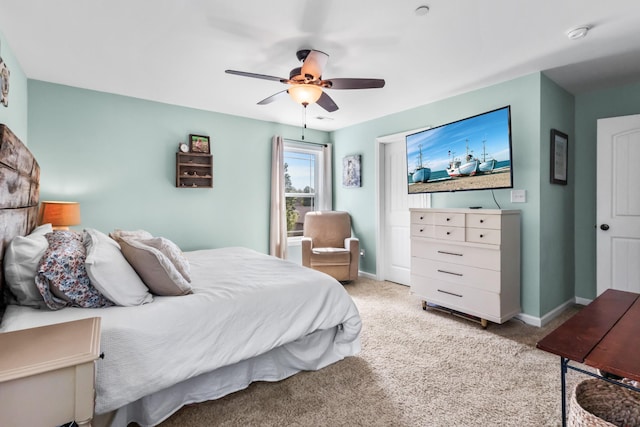 bedroom featuring baseboards, a ceiling fan, and light carpet