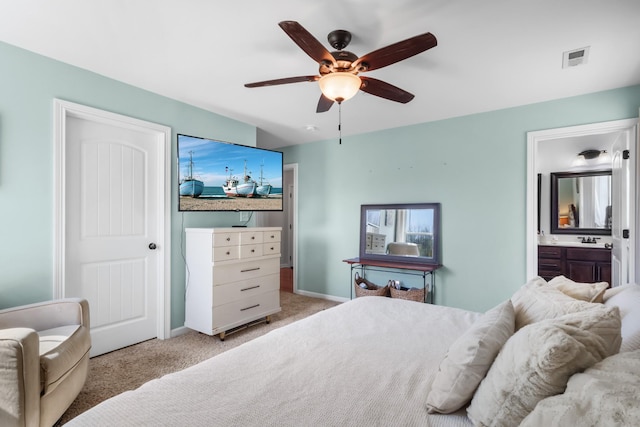 bedroom featuring ceiling fan, connected bathroom, visible vents, carpet flooring, and a sink