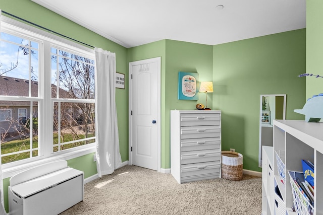 bedroom with carpet flooring, baseboards, and multiple windows