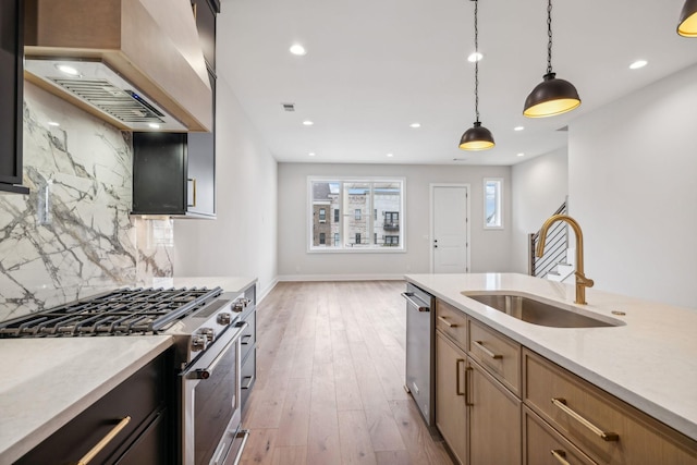 3207B Long Blvd, Nashville, TN 37203 - kitchen with tasteful backsplash, a sink, hanging light fixtures, stainless steel appliances, and custom range hood
