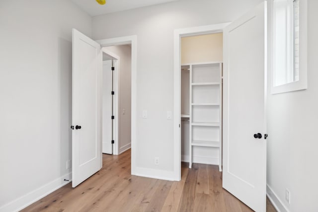 3207B Long Blvd, Nashville, TN 37203 - unfurnished bedroom featuring a closet, light wood-type flooring, a walk in closet, and baseboards