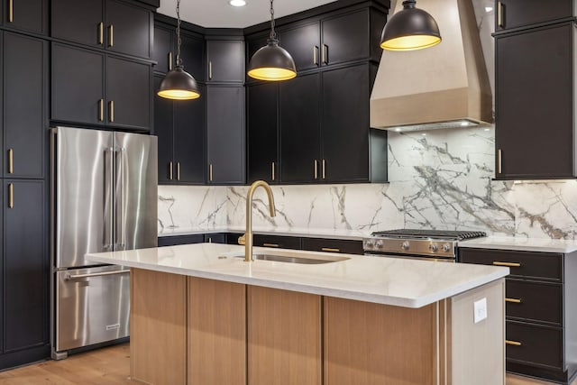 3207B Long Blvd, Nashville, TN 37203 - kitchen featuring a sink, appliances with stainless steel finishes, premium range hood, and light stone countertops