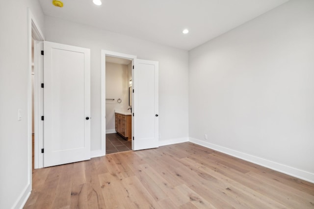 3207B Long Blvd, Nashville, TN 37203 - unfurnished bedroom with baseboards, recessed lighting, connected bathroom, and light wood-style floors