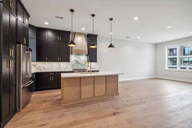 3207B Long Blvd, Nashville, TN 37203 - kitchen featuring visible vents, recessed lighting, high end refrigerator, premium range hood, and backsplash