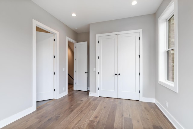 3207A Long Blvd, Nashville, TN 37203 - unfurnished bedroom featuring a closet, baseboards, recessed lighting, and wood finished floors
