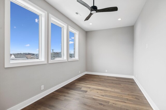 3207A Long Blvd, Nashville, TN 37203 - unfurnished room featuring a wealth of natural light, a ceiling fan, wood finished floors, and baseboards