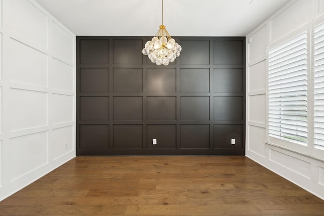 112 Shadow Springs Dr, Brentwood, TN 37027 - unfurnished dining area featuring a decorative wall, wood finished floors, and a notable chandelier