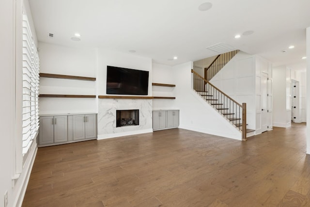 112 Shadow Springs Dr, Brentwood, TN 37027 - unfurnished living room featuring recessed lighting, stairway, wood finished floors, and a premium fireplace