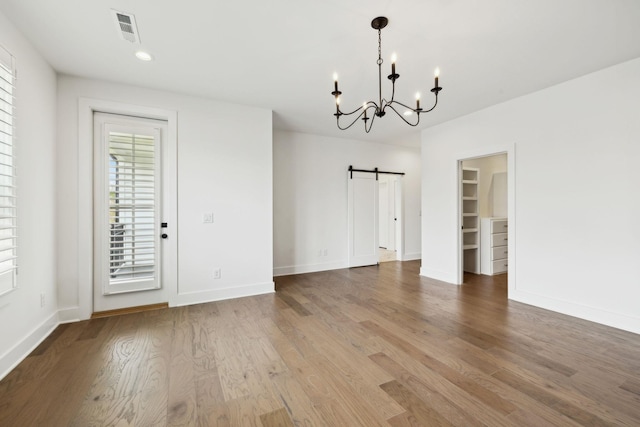 112 Shadow Springs Dr, Brentwood, TN 37027 - unfurnished dining area featuring visible vents, wood finished floors, a notable chandelier, and a barn door