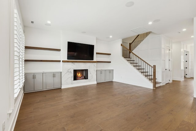 112 Shadow Springs Dr, Brentwood, TN 37027 - unfurnished living room featuring recessed lighting, stairs, wood finished floors, and a fireplace