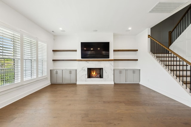 112 Shadow Springs Dr, Brentwood, TN 37027 - unfurnished living room with visible vents, baseboards, a high end fireplace, stairway, and wood finished floors