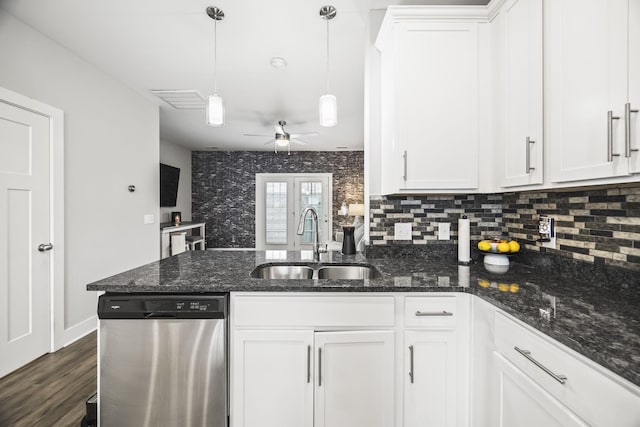 kitchen with a sink, white cabinetry, a peninsula, and dishwasher