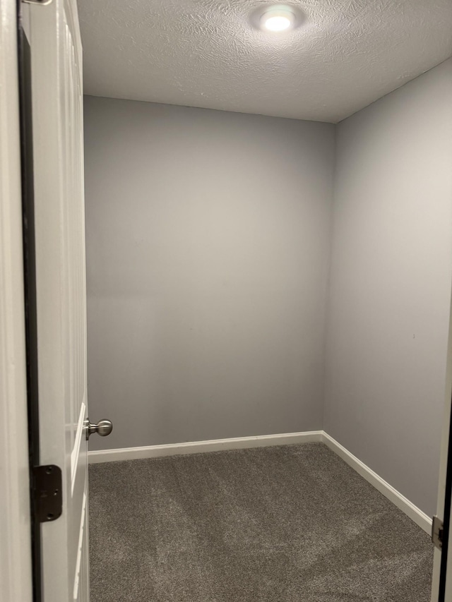 unfurnished room with baseboards and carpet
