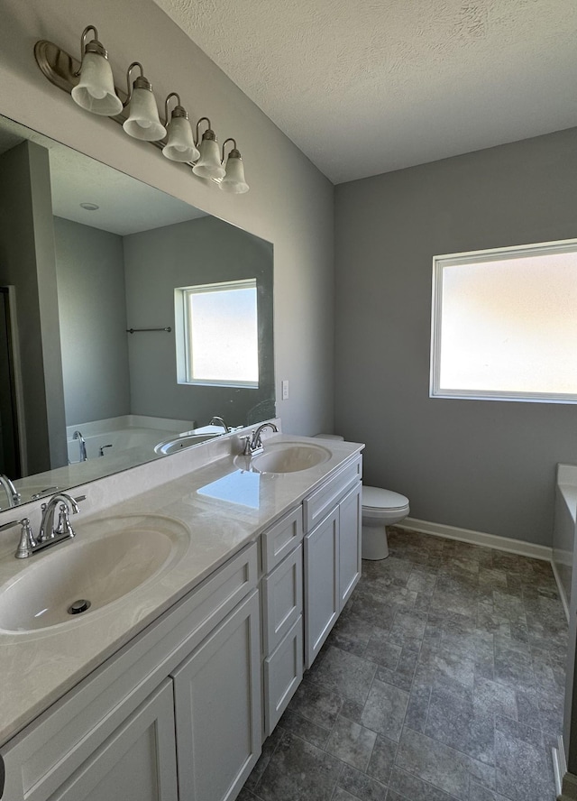 full bath featuring double vanity, a sink, and a washtub