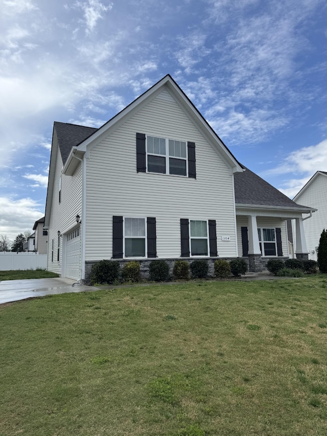 view of front of house featuring concrete driveway, a front yard, and a shingled roof