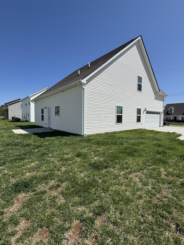 view of property exterior with a lawn, a garage, and concrete driveway