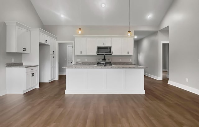 4 Young Branch Rd, Dixon Springs, TN 37057 - kitchen with stainless steel microwave, range with electric cooktop, white cabinets, and high vaulted ceiling