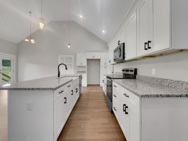 4 Young Branch Rd, Dixon Springs, TN 37057 - kitchen featuring stainless steel appliances, white cabinets, high vaulted ceiling, light wood finished floors, and decorative light fixtures