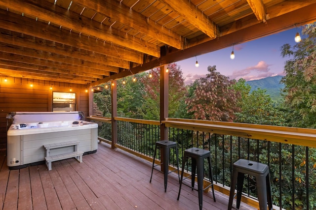 wooden terrace featuring a hot tub