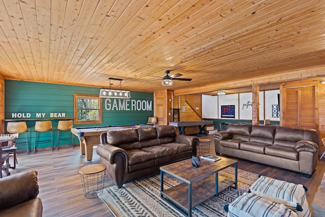 living room featuring pool table, a ceiling fan, wooden ceiling, wood walls, and wood finished floors