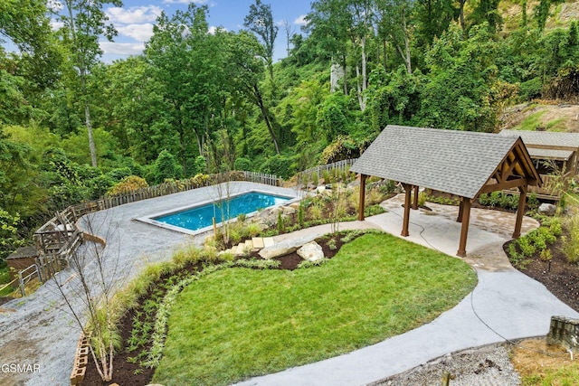 view of swimming pool with a fenced in pool, a patio, a fenced backyard, a gazebo, and a lawn