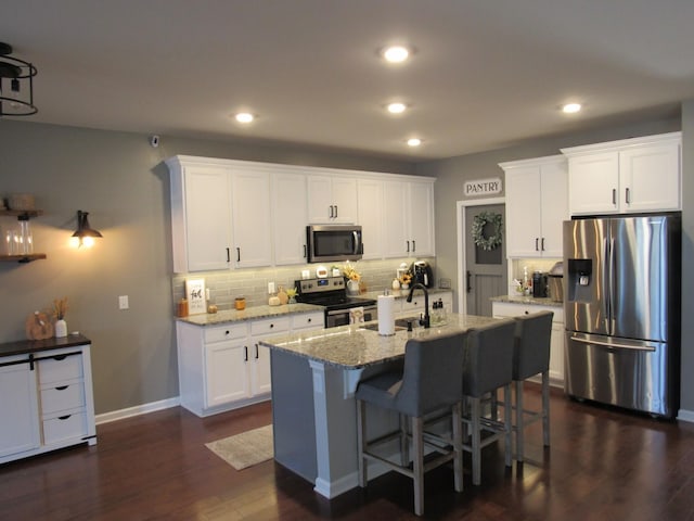 kitchen featuring white cabinetry, recessed lighting, stainless steel appliances, dark wood-type flooring, and decorative backsplash